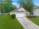 This home features an attached garage, complemented by a neat lawn and flourishing landscaping at 1042 Steelechase Ln, Hanahan, SC 29410