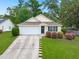 Charming single-story home features a well-manicured lawn, attached garage, and a welcoming entrance at 1042 Steelechase Ln, Hanahan, SC 29410