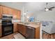 Open-concept kitchen with stainless steel appliances and wood flooring at 1042 Steelechase Ln, Hanahan, SC 29410