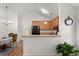 Partial view of the kitchen features cabinetry, dining room and hardwood floors at 1042 Steelechase Ln, Hanahan, SC 29410