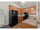 Well-lit kitchen with wood floors, ample cabinet space, and a modern black refrigerator at 1042 Steelechase Ln, Hanahan, SC 29410