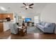 Inviting living room with vaulted ceilings, fan, hardwood flooring, and large windows at 1042 Steelechase Ln, Hanahan, SC 29410
