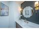 Stylish bathroom featuring modern vanity, elegant mirror, sconces, and decorative accents at 105 Glebe Rd, Summerville, SC 29485