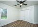 Bright bedroom with wood floor, window, ceiling fan, and closet at 105 Glebe Rd, Summerville, SC 29485