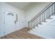 Bright foyer with wood floors, white wainscoting, staircase, and a decorative glass front door at 105 Glebe Rd, Summerville, SC 29485
