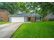 Inviting single-story home with a lush lawn, attached garage, and brick-accented entrance at 105 Glebe Rd, Summerville, SC 29485