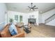 Bright living room featuring new hardwood floors, a ceiling fan, large windows, and a fireplace at 105 Glebe Rd, Summerville, SC 29485
