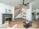 Open-concept living room featuring wood floors, a fireplace, and a view of the adjacent kitchen at 105 Glebe Rd, Summerville, SC 29485