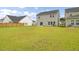 Expansive backyard featuring a well-manicured lawn and a view of the home's exterior at 105 Oast Ln, Summerville, SC 29485