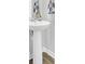Clean white pedestal sink with modern faucet and bright lighting in the bathroom at 105 Oast Ln, Summerville, SC 29485