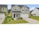 Charming two-story home with gray siding, a white garage door, and a well-manicured lawn at 105 Oast Ln, Summerville, SC 29485