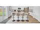 Bright kitchen featuring white cabinetry, stainless steel appliances, a spacious island, and seating for four at 105 Oast Ln, Summerville, SC 29485