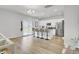 Open-concept kitchen with white cabinets, stainless steel appliances, island seating, and sliding glass doors to the backyard at 105 Oast Ln, Summerville, SC 29485