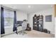 Bright home office features a modern desk, rolling chair, dark curtains, and large shelving unit at 105 Oast Ln, Summerville, SC 29485
