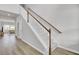 Bright staircase featuring hardwood floors, white wainscoting, and wooden banisters leading to the upper level at 105 Oast Ln, Summerville, SC 29485