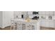 Modern kitchen featuring white cabinets, granite countertops, stainless steel appliances, and a breakfast bar at 107 Moscato Ln, Summerville, SC 29485