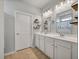 Bathroom with double sinks, white cabinetry, and decorative shelving at 111 Nolin Road Rd, Moncks Corner, SC 29461