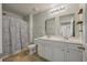 Well-lit bathroom features a double sink vanity, shower with tub, and tile flooring at 111 Nolin Road Rd, Moncks Corner, SC 29461