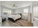 Well-lit bedroom featuring a ceiling fan, two windows, and wood-look flooring at 111 Nolin Road Rd, Moncks Corner, SC 29461