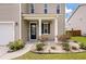 Front door entrance with a black front door, white columns, and well maintained landscaping at 111 Nolin Road Rd, Moncks Corner, SC 29461