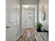 Light and airy hallway with hardwood floors, white doors and modern decor at 111 Nolin Road Rd, Moncks Corner, SC 29461