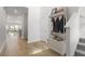 Inviting foyer featuring hardwood floors, a storage bench, and views into the open-concept living space at 122 Lefton Lndg, Summerville, SC 29485