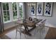 Bright dining room with an elegant chandelier, large windows and a rustic dining table at 124 Maritime Way, Summerville, SC 29485