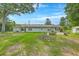 Expansive green backyard with trees, garden beds, and a home with neutral siding at 1314 Cooper Store Rd, Moncks Corner, SC 29461
