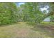 Expansive backyard featuring lush greenery and mature trees, providing a private and serene outdoor space at 1314 Cooper Store Rd, Moncks Corner, SC 29461