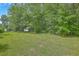 Expansive grassy backyard with mature trees and an outbuilding at 1314 Cooper Store Rd, Moncks Corner, SC 29461