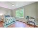 This bedroom includes hardwood flooring, and a large window at 1314 Cooper Store Rd, Moncks Corner, SC 29461