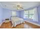 This bedroom includes hardwood flooring, curtains and a large window at 1314 Cooper Store Rd, Moncks Corner, SC 29461