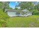 Charming single-story home with green grass, mature landscaping, and a welcoming front porch at 1314 Cooper Store Rd, Moncks Corner, SC 29461