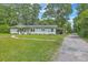 Well-manicured front yard with landscaping, and a home with a carport at 1314 Cooper Store Rd, Moncks Corner, SC 29461