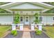 Inviting front porch with stylish columns, greenery, and decorative accents at 1314 Cooper Store Rd, Moncks Corner, SC 29461