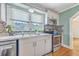 Bright kitchen features a double stainless steel sink, modern appliances, and scenic window view at 1314 Cooper Store Rd, Moncks Corner, SC 29461