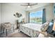 Charming bedroom featuring a cozy bed, a large window with a backyard view, and coastal decor at 141 Pine Crest View Dr, Summerville, SC 29486