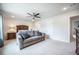 A bedroom with a ceiling fan, a sitting area with a comfortable sofa, and neutral carpet flooring at 141 Pine Crest View Dr, Summerville, SC 29486