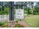 The Pine Crest community sign with lush landscaping, a white fence and natural foliage at 141 Pine Crest View Dr, Summerville, SC 29486