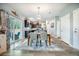 Open-concept dining area showcasing a wood table with seating for four, adjacent to the kitchen and living room at 141 Pine Crest View Dr, Summerville, SC 29486