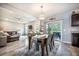 A dining area with a wood table and seating for four adjoins the living room and offers outdoor access at 141 Pine Crest View Dr, Summerville, SC 29486