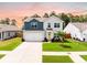 Charming two-story home featuring blue and gray siding, a two-car garage, and a well-maintained lawn at 141 Pine Crest View Dr, Summerville, SC 29486