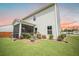 Well-manicured landscaping enhances the exterior of this home with a screened porch at 141 Pine Crest View Dr, Summerville, SC 29486