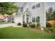 Charming two-story home with blue and gray siding, and a landscaped front yard with colorful flowers at 141 Pine Crest View Dr, Summerville, SC 29486