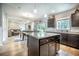 Open-concept kitchen showcasing dark wood cabinets, granite countertops, and seamless flow into the dining and living areas at 141 Pine Crest View Dr, Summerville, SC 29486