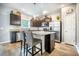 A kitchen with stainless steel appliances, dark wood cabinets, and a central island with bar seating at 141 Pine Crest View Dr, Summerville, SC 29486