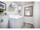 Practical laundry room featuring a white washer and dryer with upper storage shelves at 141 Pine Crest View Dr, Summerville, SC 29486