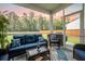 Comfortable screened porch features wicker seating and a view of the lush backyard at 141 Pine Crest View Dr, Summerville, SC 29486