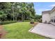 Lush backyard with a patio area, well-maintained lawn, and privacy hedging at 1445 Ashley Gardens Blvd, Charleston, SC 29414