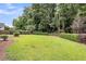 Large backyard featuring a well maintained lawn, hedging, and mature trees at 1445 Ashley Gardens Blvd, Charleston, SC 29414